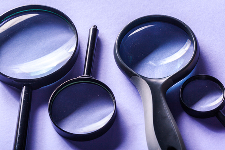 Magnifier on blue background close upの写真素材