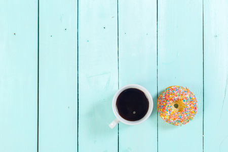 Donuts and coffee on wooden table. Top viewの写真素材