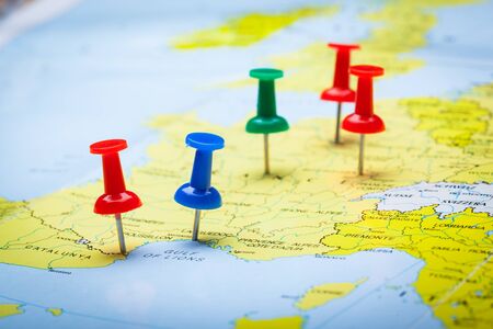Travel destination points on a map indicated with colorful thumbtacks