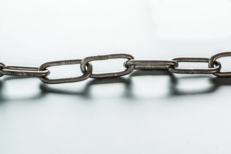 close up of metal chain part on white background
