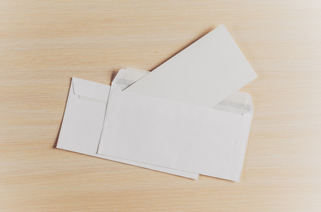 Blank envelopes on a wooden background