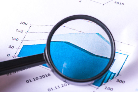 Magnifying glass and business growth graphの写真素材