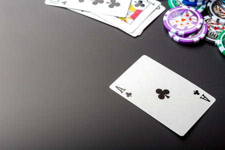 poker chips and cards on black background