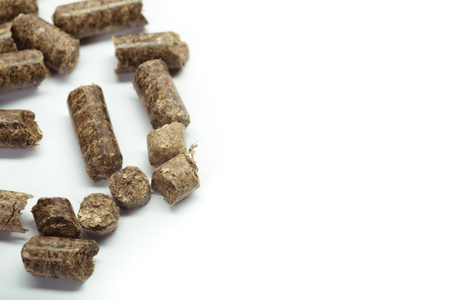 stack of wooden pellets for bio energy, white background, isolated