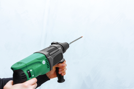 Use hammer drill to drill the wallの写真素材