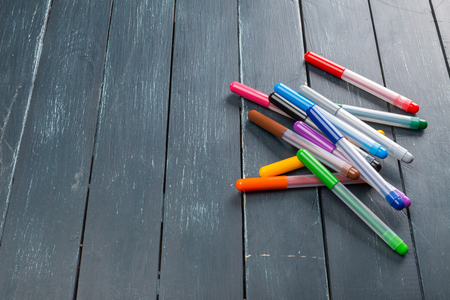 Colored marker pens on wood backgroundの写真素材