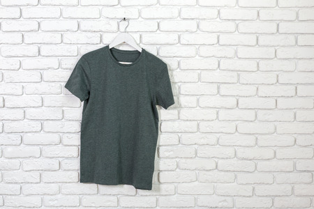 brick whitewashed wall with t-shirt on hanger