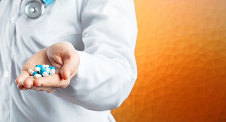 Doctor holding pillsの写真素材