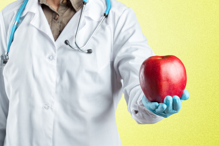dentist holding a ripe appleの写真素材