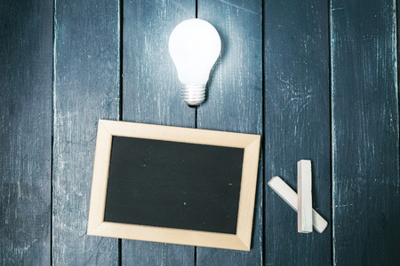 Small blackboard on old wood backgroundの写真素材