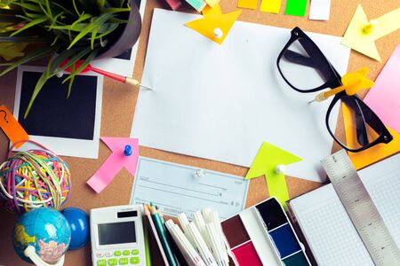 Desk of an artist with lots of stationery objects