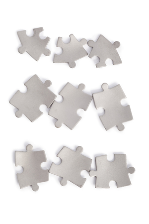 Metal puzzle pieces isolated on whiteの写真素材