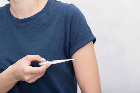 Sick women with a thermometerの写真素材