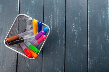 Colored marker pens on wood backgroundの写真素材