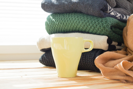 Stack of white cozy knitted sweatersの写真素材