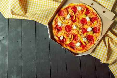 Fresh tasty pizza on wooden backgroundの写真素材