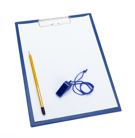 A blank clipboard and a coaches whistle with copy spaceの写真素材