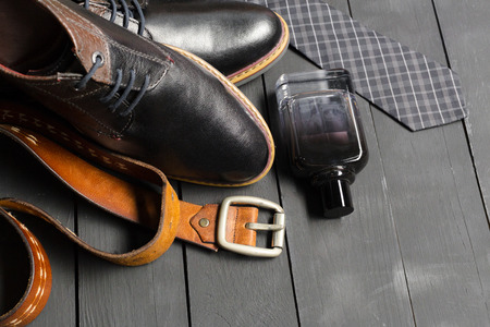 shoes and accessories for men lay on the wooden floorの写真素材