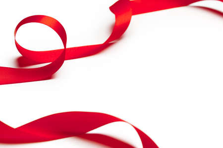 Red ribbon on white backgroundの写真素材