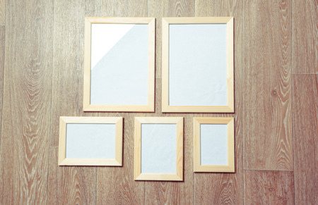 photo frames on the wooden wall