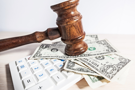 judge gavel and money on brown wooden table conceptの写真素材