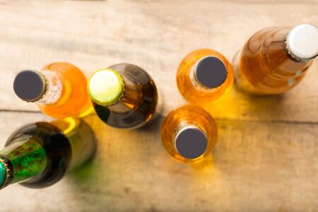 Beer bottles on a wooden table .の写真素材