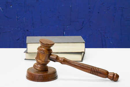 Wooden gavel and books on wooden table
