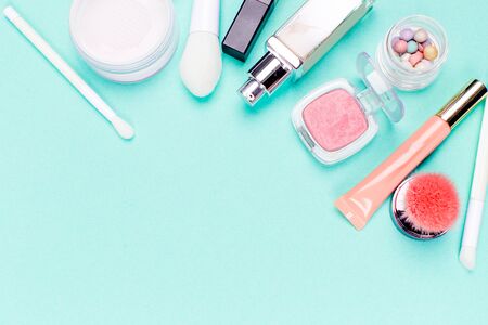 Colorful cosmetics on blue workplace. Top viewの写真素材