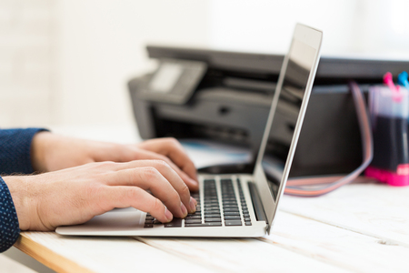 Man's hand making copies. Working with printer