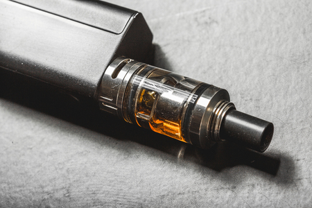 The most popelar modern electronic cigarette over black background. Vape. Vapor.の写真素材