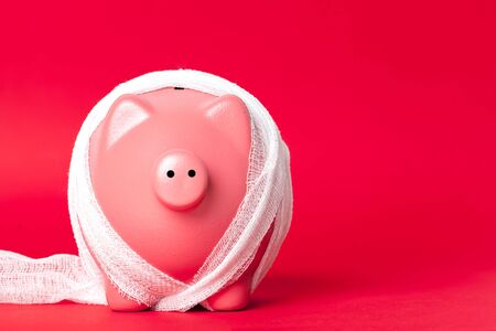 piggy bank with a white bandageの写真素材