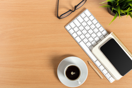working place at wooden desktop with coffeeの写真素材