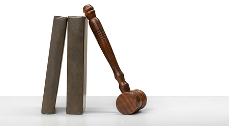 Wooden gavel and books on wooden tableの写真素材