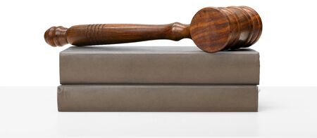 Wooden gavel and books on wooden tableの写真素材