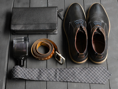 shoes and accessories for men lay on the wooden floorの写真素材