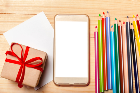 Smart phone and gift on wooden backgroundの写真素材