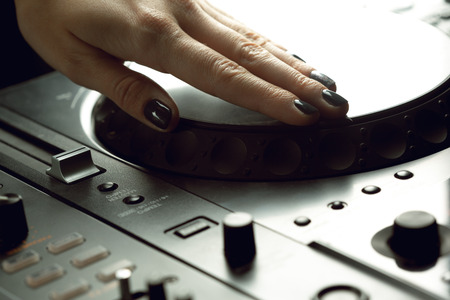 DJ playing music at mixer closeup
