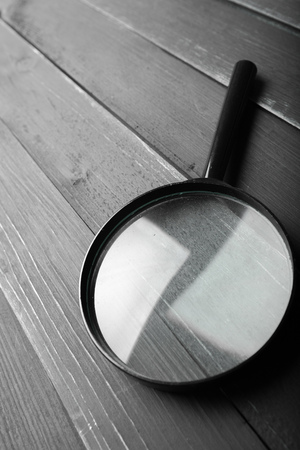 magnifying glass or loupe on wooden tableの写真素材