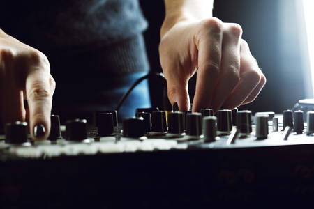 DJ playing music at mixer closeupの写真素材