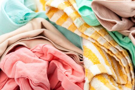 Clothes in a laundry wooden basket isolated on white backgroundの写真素材