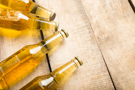 Beer bottles on a wooden table .の写真素材
