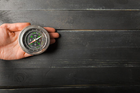 Man Hand Holding Chrome Compass