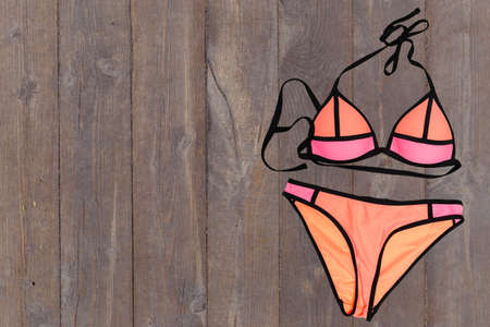 swimsuit on wooden background. top viewの写真素材