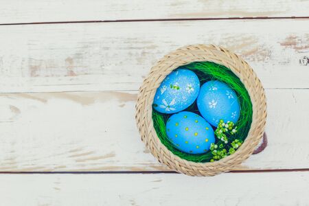 Easter eggs painted in pastel colors on white wooden background.の写真素材