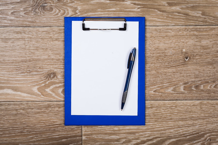 blank notebook and pen on the tableの写真素材