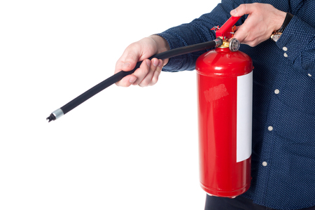 Man using fire extinguisher isolated on whiteの写真素材