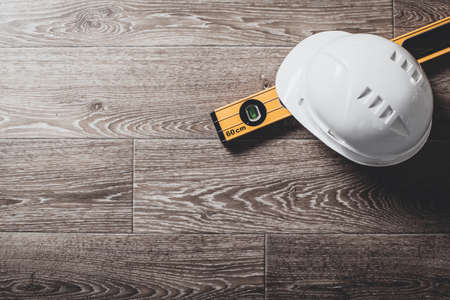 Safety helmet and tools to architect on wooden background