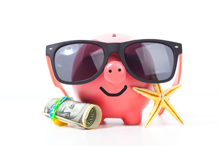 Pink piggy bank with glasses isolated on a whiteの写真素材