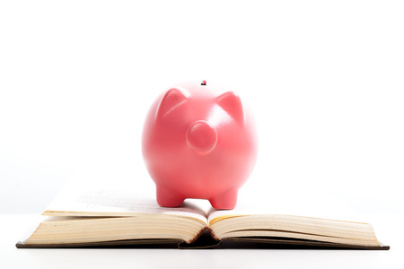 piggy bank on a stack of book concept of education costsの写真素材