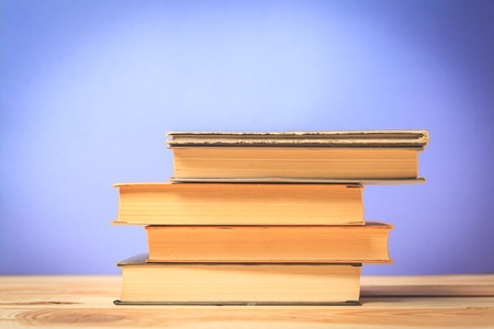 Vintage old books on wooden deck tableの写真素材